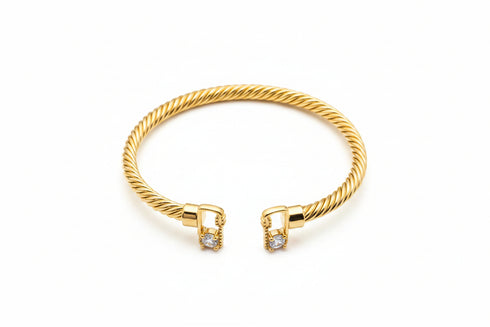 Gold bracelet with diamond accents on a marble surface