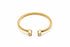 Gold bracelet with diamond accents on a marble surface
