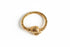 Gold ring with a textured design on a white background