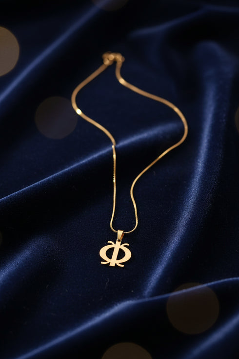 Gold necklace on a marble surface