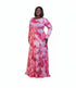 A woman modeling a long-sleeve maxi dress with a pink and white marble pattern, standing against a plain white background.