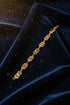 Gold bracelet on a marble surface