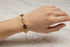 Gold bracelet on a marble surface
