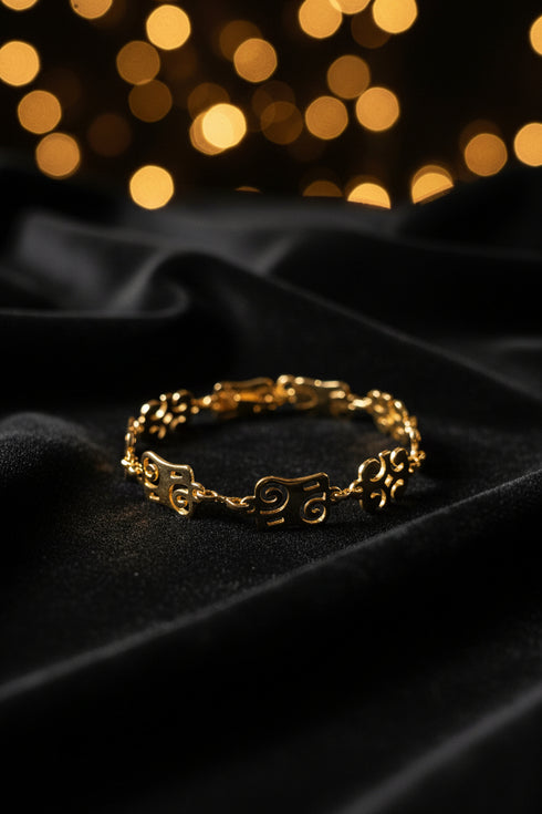 Gold bracelet on a marble surface