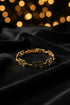 Gold bracelet on a marble surface