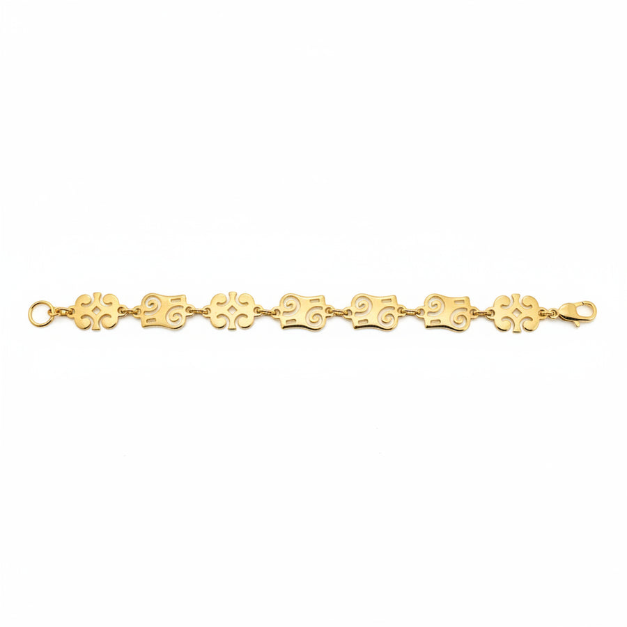 Gold bracelet with floral links on a white background