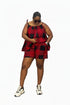 A woman modeling a red and black checkered sparkly romper with white sneakers, standing in front of a black and white striped wall. A phone screen overlay is visible in the bottom left, and a black label with 'MAD042' is on the right.