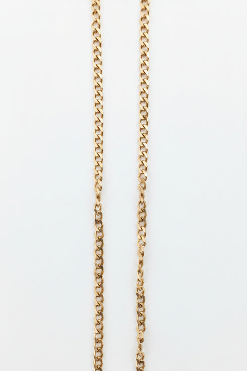 Gold chain on a marble surface