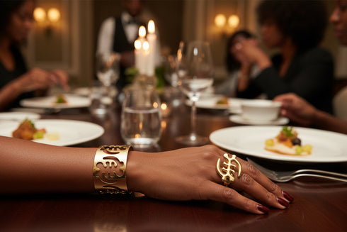 Gold bracelet with cut-out designs on a marble surface