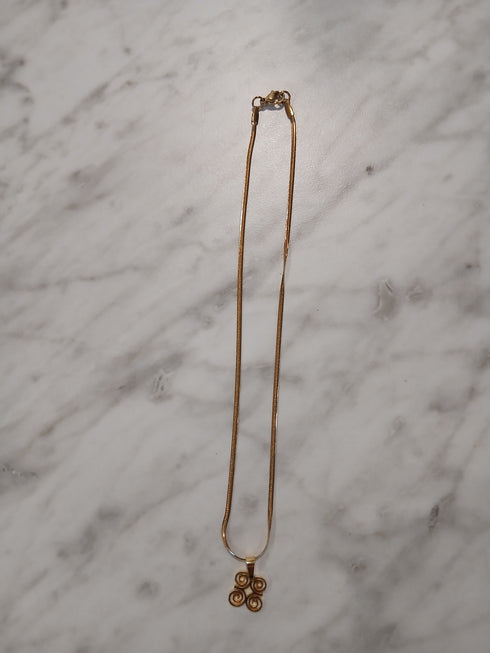 Gold hair clip on a marble surface