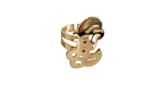 Gold ring with a unique design on a marble surface