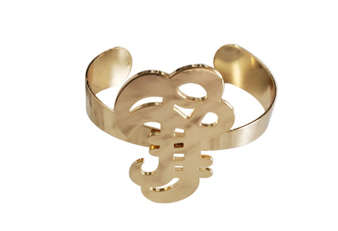 Gold bracelet with intricate design on a white background