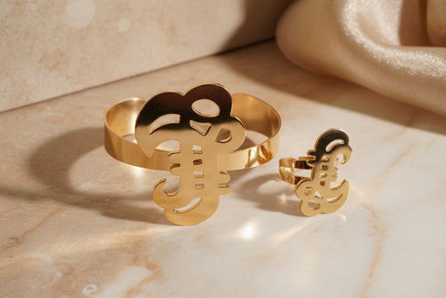 Gold guitar-shaped bracelet on a marble background