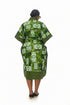 A woman viewed from behind wearing a green and white patterned kaftan robe with short wide sleeves, standing against a plain white background.