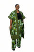 A person modeling a green and black patterned cotton kaftan jacket and matching trousers, shown in a video-style social media post with text overlays detailing the fabric and garment information.